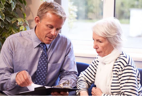 Doctor consults with elderly patient on patient choice