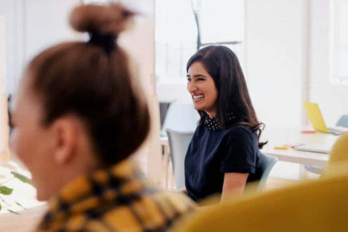 Woman smiling in an office on the first day at a new job