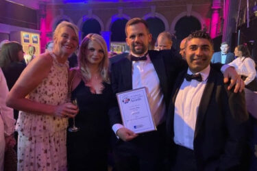 IUC staff pose with their award