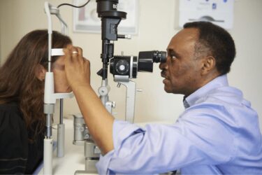 an eye technician checking a patient