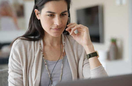 A call centre worker talks on the phone about healthcare recruitment