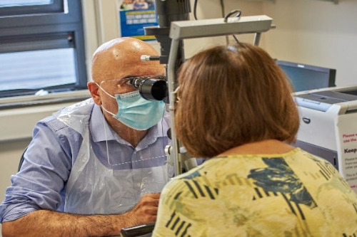 Optometrist studies a patient at mobile eye service in Yorkshire