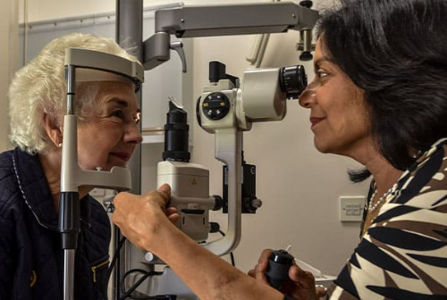 An optometrist tests a patient's eyes