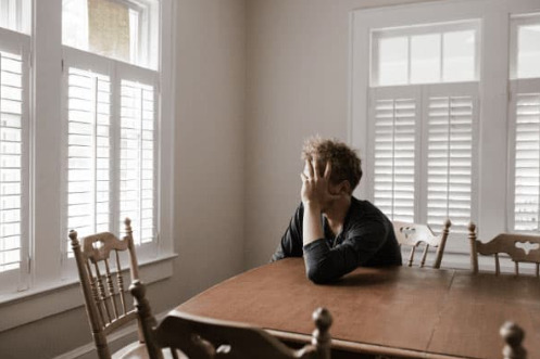 Anxious man looks out of window