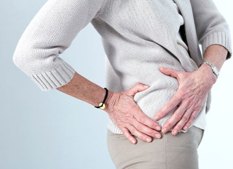 Woman holds a painful hip