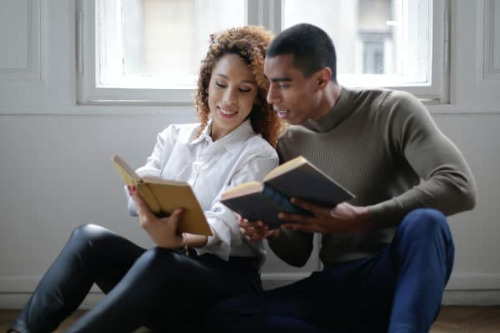 Couple read books together at home