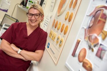 an optometrist smiles in her office