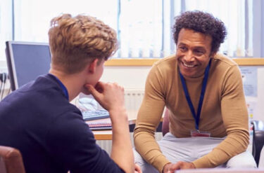 Two men talking at a recruitment event