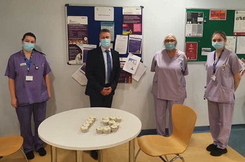 Staff from Plymouth Hospital celebrate 15 years with cake