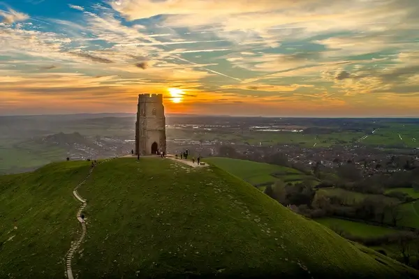 An image of a Glastonbury tor hill at sunset