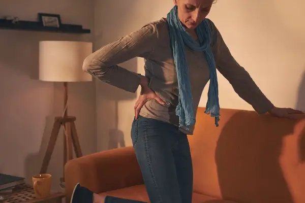Woman with a hernia holding her lower back