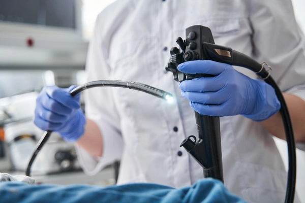 Medical professional holding endoscopy equipment 
