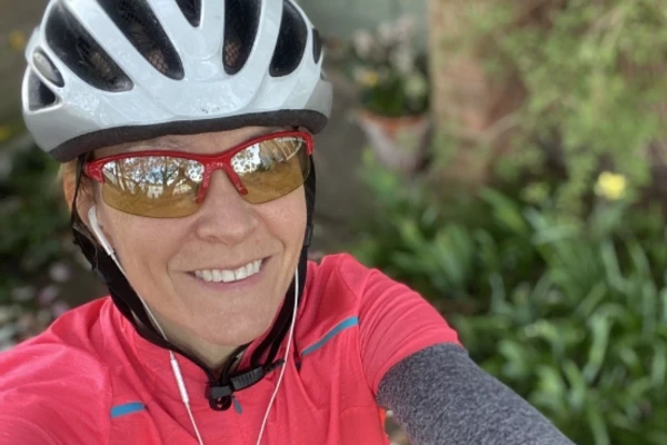 A smiling Dr Hocking in a bike helmet