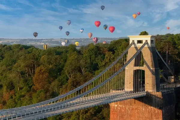 Bridge in Bristol with hot air balloons floating by