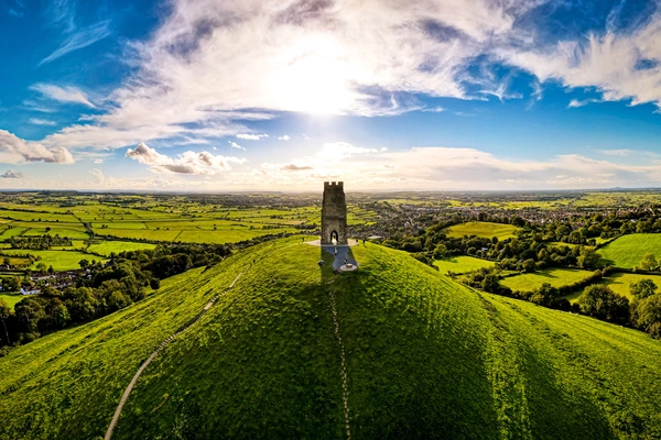 A structure on a hilltop in Somerset on a blue sky day