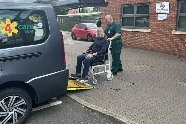 David being pushed into his transport as part of our door-to-door hip replacement service