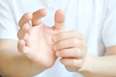 person holding their thumb, thumb replacement