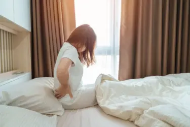 hip pain at night woman in pain on bed